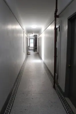 a long hallway with a light on the side of a building at Private Studio Near Columbia Presbyterian Hospital in New York