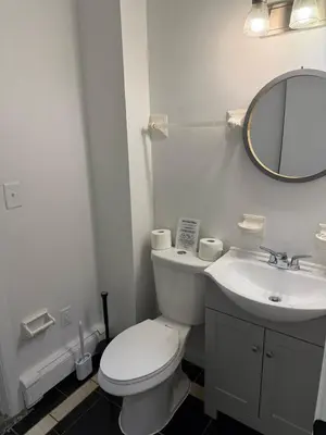a bathroom with a white toilet and a sink at Luxury Boutique Home - 4 Beds 1 Baths 25 minutes to NYC in Jersey City
