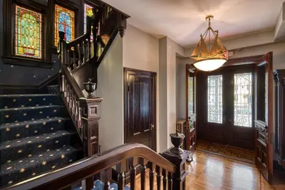 a hallway with a staircase and stained glass windows at Hudson Navigator in Hudson