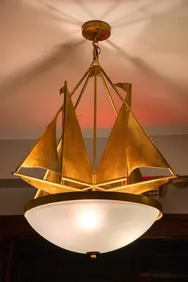 a chandelier with a paper boat on it at Hudson Navigator in Hudson