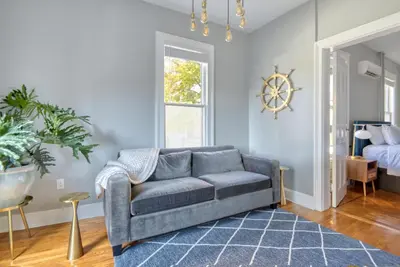 a living room with a couch and a bed at Hudson Navigator in Hudson