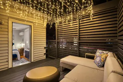 a room with a couch and a table and lights at Hudson Navigator in Hudson