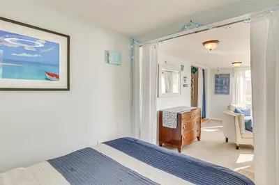 a bedroom with a bed and a desk and a chair at Beachfront, Dog-Friendly Milford Getaway with Yard! in Milford