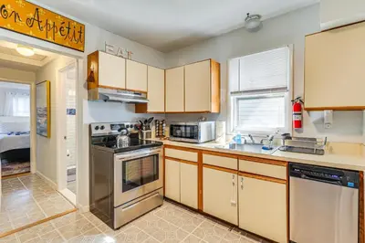 a kitchen with a sink and a stove top oven at Beachfront, Dog-Friendly Milford Getaway with Yard! in Milford