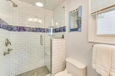 a bathroom with a toilet and a glass shower at Beachfront, Dog-Friendly Milford Getaway with Yard! in Milford