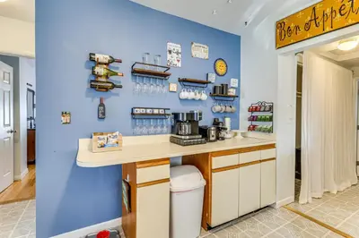a kitchen with a counter and a blue wall at Beachfront, Dog-Friendly Milford Getaway with Yard! in Milford