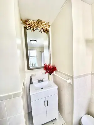 a bathroom with a sink and a mirror at Apart Studio West NYNJ 12Mints From NYCity TimeSquare in West New York