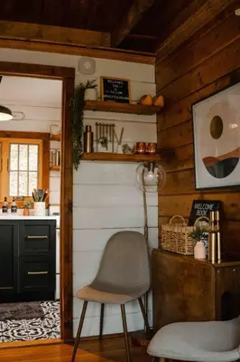 a kitchen with a chair and a table and a counter at The Little Lake Cabin in New Fairfield