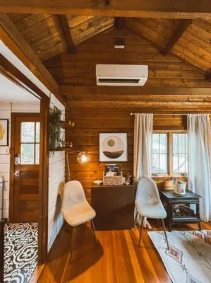 a living room with a desk and two chairs at The Little Lake Cabin in New Fairfield