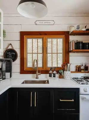 a kitchen with a sink and a stove at The Little Lake Cabin in New Fairfield