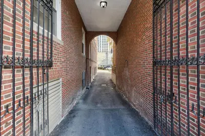 an alley with an archway in a brick building at Washington Lofts 109 Spacious 1 Bedroom 1 Bath in Albany