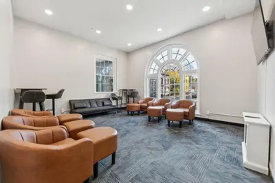 a waiting room with chairs and a tv at Washington Lofts 109 Spacious 1 Bedroom 1 Bath in Albany