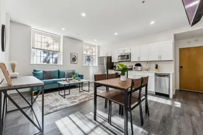 a kitchen and living room with a couch and a table at Washington Lofts 109 Spacious 1 Bedroom 1 Bath in Albany