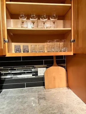 a cupboard filled with glasses of wine at Holyoke House Oasis - Fast Wifi, Spacious, Quiet Neighborhood in Holyoke