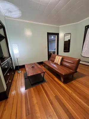 a living room with a couch and a coffee table at Holyoke House Oasis - Fast Wifi, Spacious, Quiet Neighborhood in Holyoke