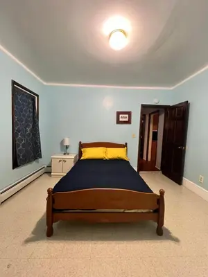 a bedroom with a bed in a blue room at Holyoke House Oasis - Fast Wifi, Spacious, Quiet Neighborhood in Holyoke