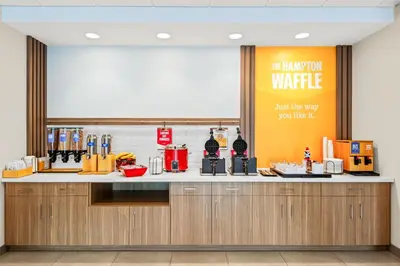 a kitchen with a counter top with avertisement for at Hampton Inn Cooperstown in Cooperstown