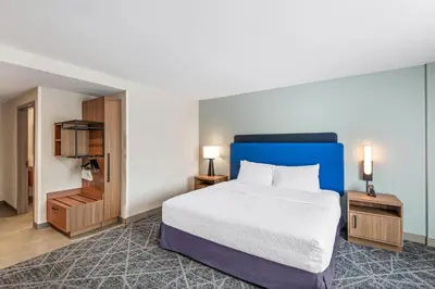 a hotel room with a bed and two night stands at Hampton Inn Cooperstown in Cooperstown