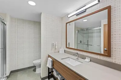 a bathroom with a sink and a mirror at Hampton Inn Cooperstown in Cooperstown