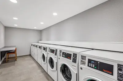 a row of washing machines in a laundry room at Hampton Inn Cooperstown in Cooperstown
