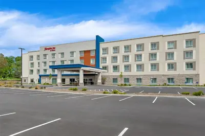 an empty parking lot in front of a hotel at Hampton Inn Cooperstown in Cooperstown