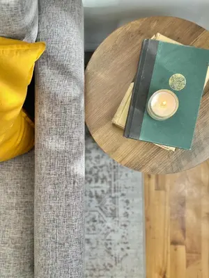 a wooden table with a candle on top of it at Cottage 215 Apartments in New York