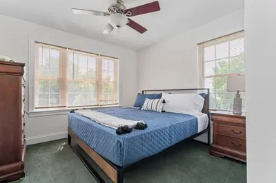 a bedroom with a bed and a ceiling fan at The Hera Haven - Pickleball, hot tub, racetrack & lake in Stillwater