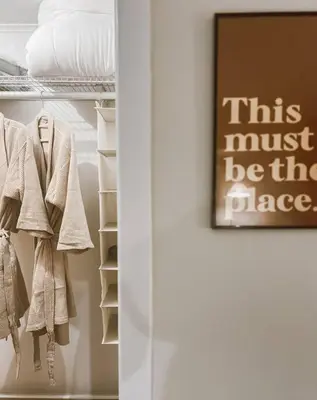a closet with a sign that says this must be the place at Creek Side Cabin with Wood Fired Hot Tub and Fire Pit in New Milford