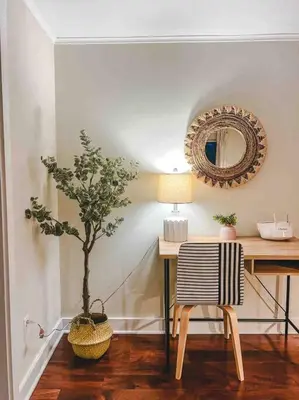 a table with a chair and a tree in a room at Creek Side Cabin with Wood Fired Hot Tub and Fire Pit in New Milford