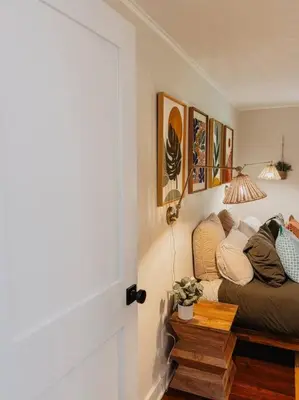 a room with a couch and some pictures on the wall at Creek Side Cabin with Wood Fired Hot Tub and Fire Pit in New Milford