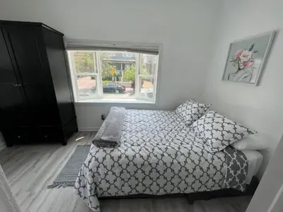 a bedroom with a bed and a window at Spacious 3 bedroom close to NYC in North Bergen