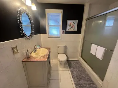 a bathroom with a toilet and a sink and a shower at Spacious 3 bedroom close to NYC in North Bergen