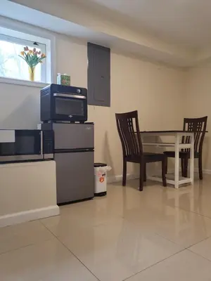 a living room with a table and two chairs and a television at Serenity Escape in Hudson Valley in Hopewell Junction