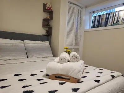 a bedroom with a bed with towels on it at Serenity Escape in Hudson Valley in Hopewell Junction