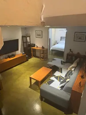 a living room with a couch and a table at Cozy and Comfy Cellar in Yonkers