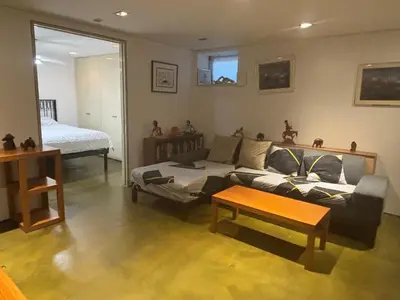 a living room with a couch and a coffee table at Cozy and Comfy Cellar in Yonkers