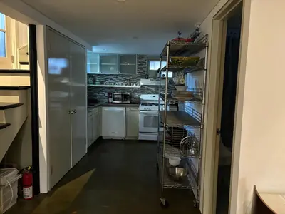 a kitchen with white cabinets and white appliances at Cozy and Comfy Cellar in Yonkers