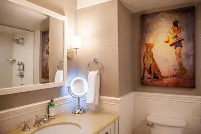a bathroom with a sink and a painting on the wall at Delamar Westport in Westport