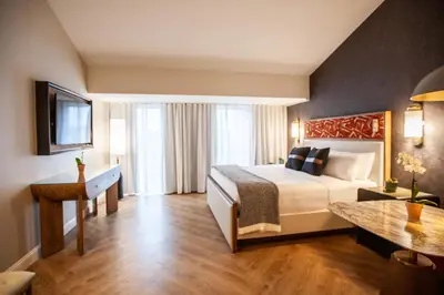 a hotel room with a bed and a table at Delamar Westport in Westport