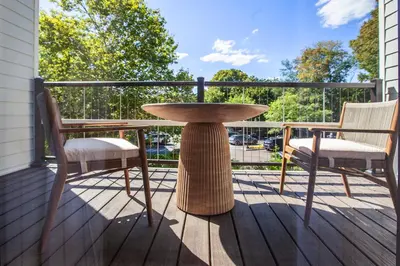 a table and two chairs sitting on a porch at Delamar Westport in Westport