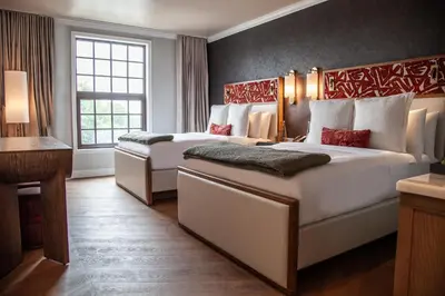 a hotel room with two beds and a window at Delamar Westport in Westport