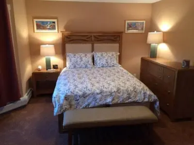 a bedroom with a large bed and two night stands at MOUNT SNOW GREENSPRING 41d in West Dover