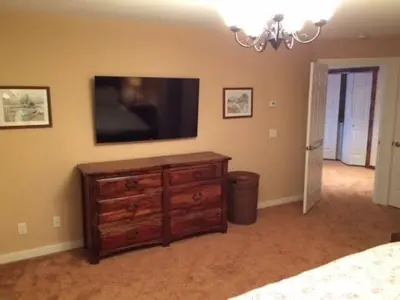 a bedroom with a dresser and a flat screen tv at MOUNT SNOW GREENSPRING 41d in West Dover