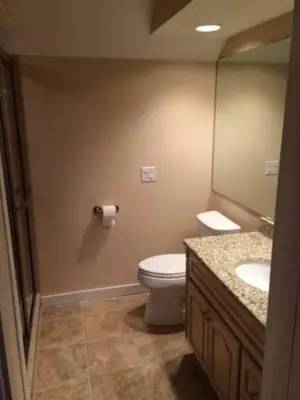 a bathroom with a toilet and a sink and a mirror at MOUNT SNOW GREENSPRING 41d in West Dover