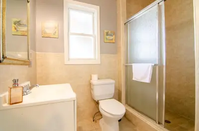 a bathroom with a toilet and a sink and a shower at Near NYC Spacious 4 bedroom 2 and a half bath in North Bergen