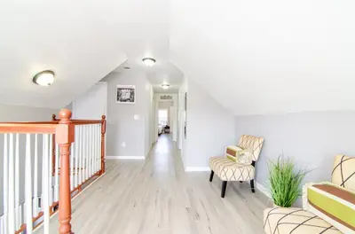a living room with a staircase and a chair at Near NYC Spacious 4 bedroom 2 and a half bath in North Bergen