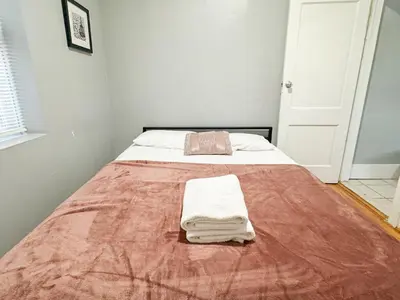 a bed with two towels on it in a bedroom at 3 bed 1 bath FREE parking near NYC in North Bergen