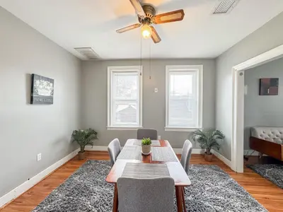 a dining room with a table and a ceiling fan at 3 bed 1 bath FREE parking near NYC in North Bergen