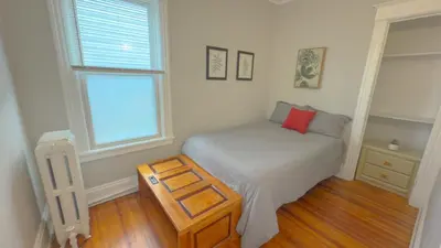 a small bedroom with a bed and a window at The Rustic Home Albany NY - 3 Bedroom Private Second Floor Apartment in Albany