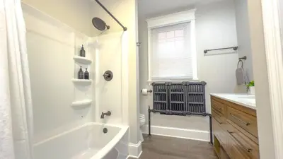 a white bathroom with a tub and a sink at The Rustic Home Albany NY - 3 Bedroom Private Second Floor Apartment in Albany